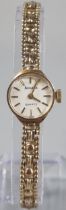 Accurist 9ct gold small head ladies wristwatch with satin face having baton numerals on a 9ct gold