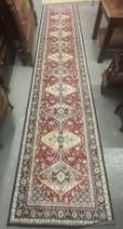 Multi-coloured field Kashan runner with repeating medallion designs. 405x80cm approx. (B.P. 21% +