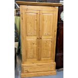 Modern natural pine finish two door panelled wardrobe with drawer below. 105cm wide approx. (B.P.