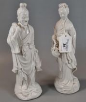 Two Chinese porcelain blanc de chine figures of a fisherman with his net and a maiden carrying a