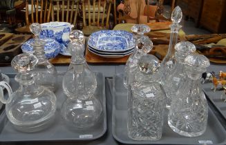 Two trays of glass decanters with stoppers to include: cut glass with star cut bases in various