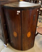 19th century mahogany bow front blind panelled hanging corner cupboard with shell motifs. (B.P.