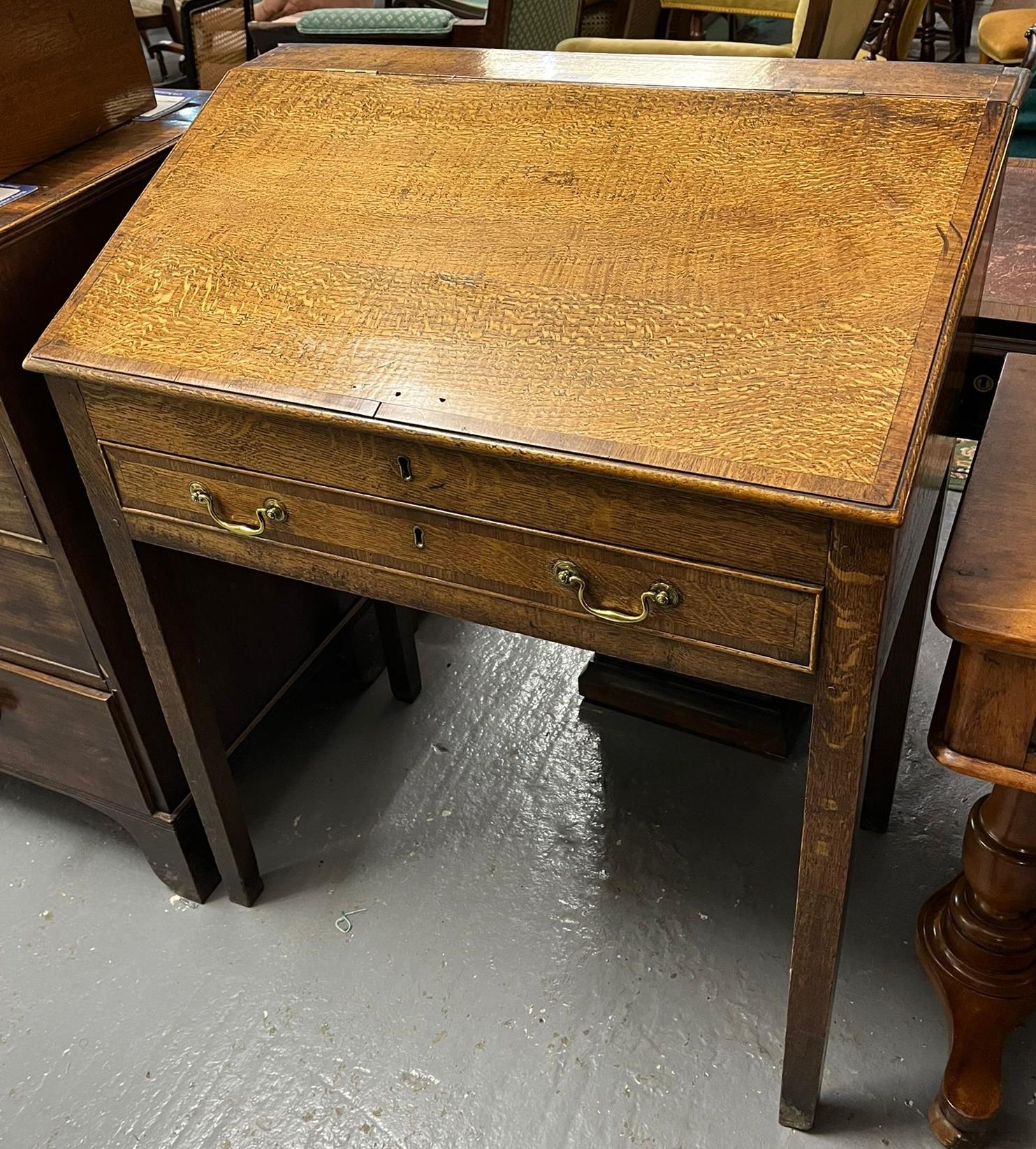 Early 19th century oak fall front clerk's desk with single cock beaded drawer on square tapering