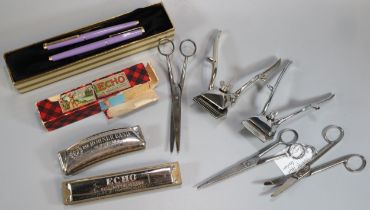 Box of oddments to include: Hohner Echobell harmonica and another Hohner harmonica, writing pens,