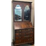 18th century mahogany bureau bookcase with beveled mirrored doors, the slope front revealing