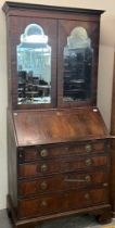 18th century mahogany bureau bookcase with beveled mirrored doors, the slope front revealing