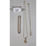 9ct gold fine link chain with abstract pendant together with a 9ct gold curb link bracelet and