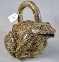 An unusual yellow glazed ceramic pouring vessel in the form of a frog/toad, overall decorated with