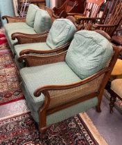 Early 20th century walnut single caned bergere suit comprising two seated sofa and a pair of chairs.