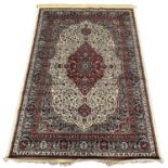 Ivory ground full pile Kashmir rug with traditional floral medallion designs. 230 x 160cm approx. (