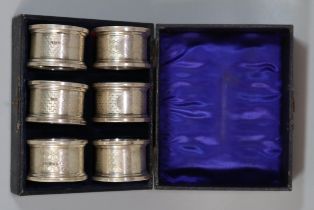 Cased set of six silver engine turned napkin rings. 2.1 troy oz approx. (B.P. 21% + VAT)