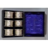 Cased set of six silver engine turned napkin rings. 2.1 troy oz approx. (B.P. 21% + VAT)