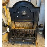 Cast Iron dog grate with arched lion mask back and fire brick lined basket with ash drawer below.