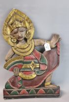 Carved polychrome figure of an Indonesian dancer wall plaque. 50cm high approx. (B.P. 21% + VAT)