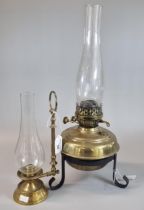 Early 20th century double oil burner lamp having clear glass chimney on a brass reservoir and