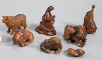 Collection of Japanese carved boxwood netsukes to include: frogs, carp, wild boar, snake, elephant