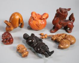Bag of assorted carved netsukes to include: Foo Dog, hare, fish, rats, figurine of an old man