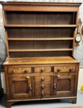 Early 19th century North Wales oak two stage dresser, the moulded top with three shelf boarded rack,