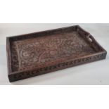 Indian hardwood ornately carved floral and foliate two handled tray with hand holes. (B.P. 21% +