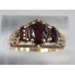 9ct gold three stone garnet ring. 2.8g approx. Size L1/2. (B.P. 21% + VAT)