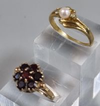 9ct gold garnet cluster flower head ring. 2.9g approx. Ring Size M. Together with a dress ring. (