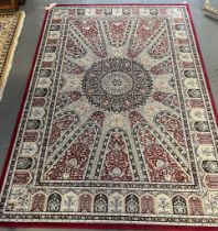 Middle eastern design cream and multi-coloured carpet with central floral medallion and repeating