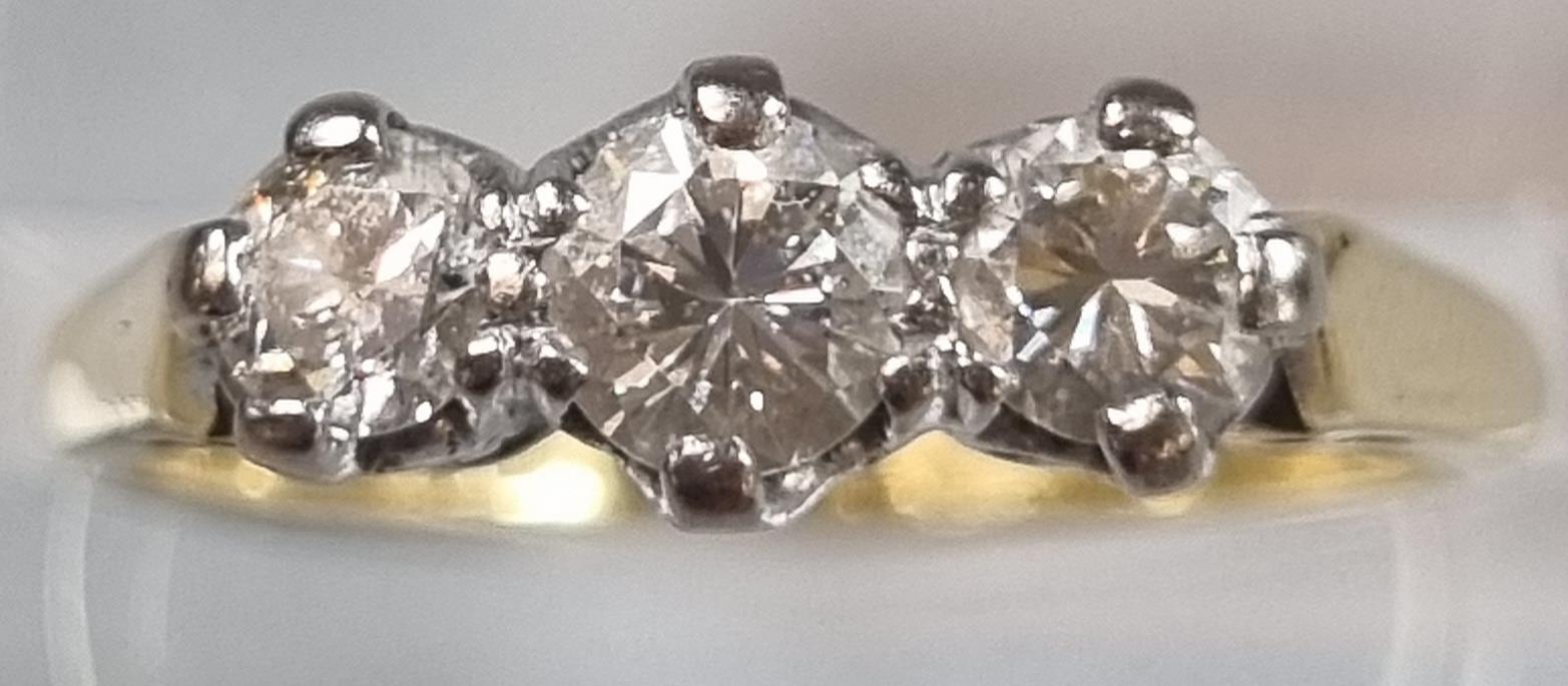 18ct gold three stone diamond ring. 3g approx. Size M. (B.P. 21% + VAT)