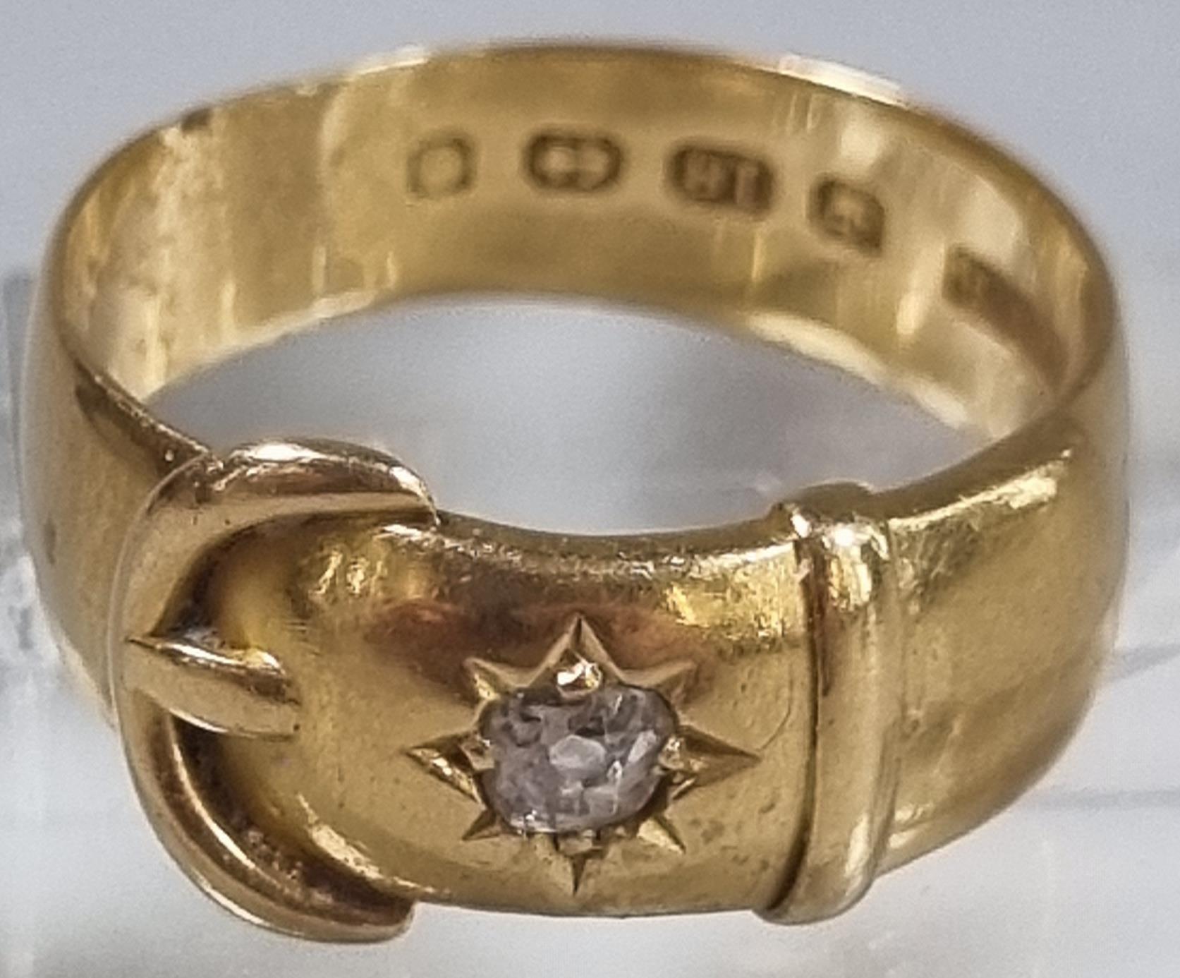 18ct gold buckle ring with inset diamond chip. 6.4g approx. Size P1/2. (B.P. 21% + VAT)