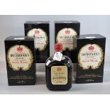 Five bottles of Buchanan's 'De Luxe' Finest Blended Scotch Whisky. 70% proof 26 2/3 ozs. Four with