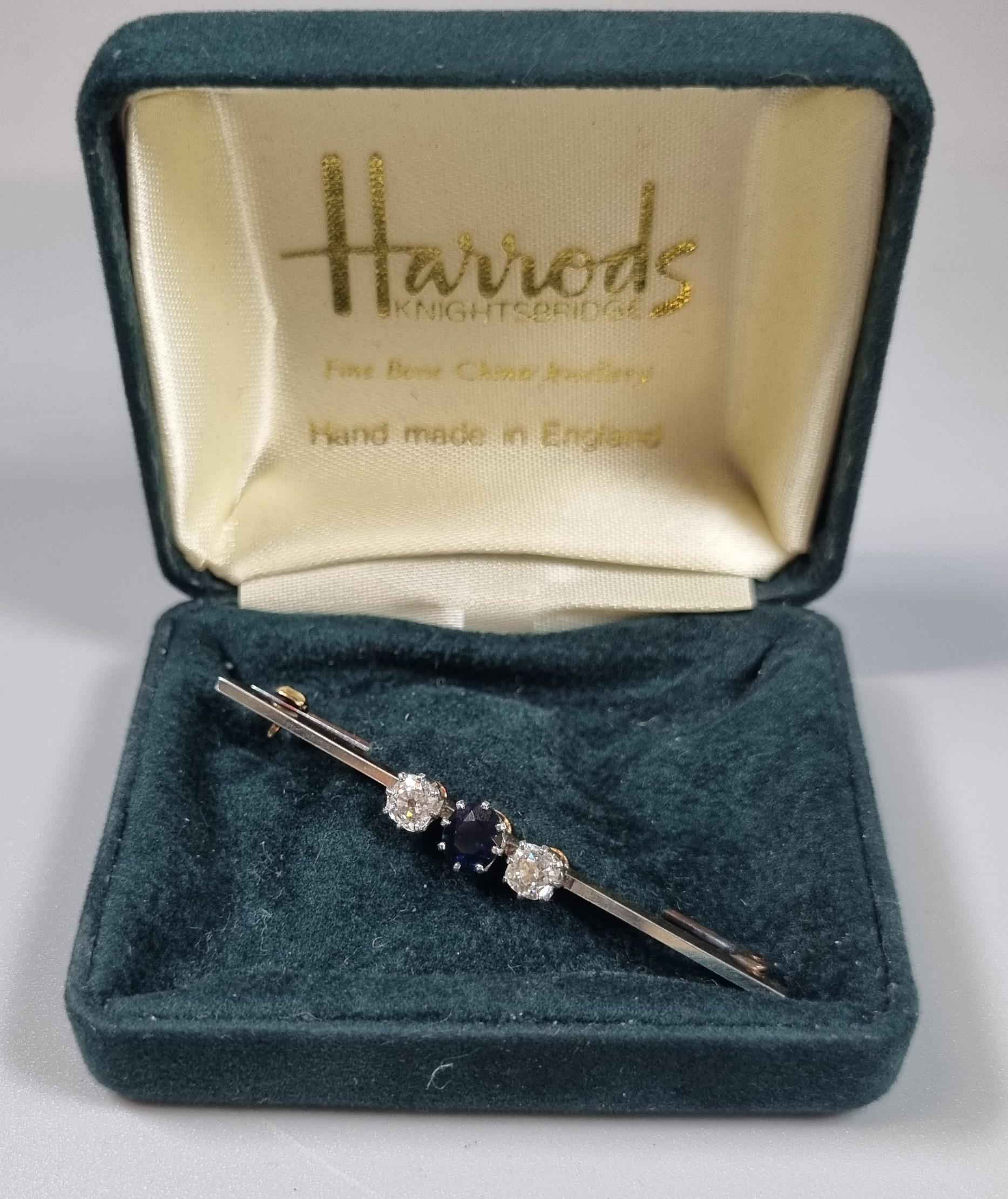 Gold three stone diamond and sapphire brooch in associate Harrods box. (B.P. 21% + VAT)