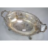 George V silver ornate and pierced two handled centre bowl, raised and standing on four shell and