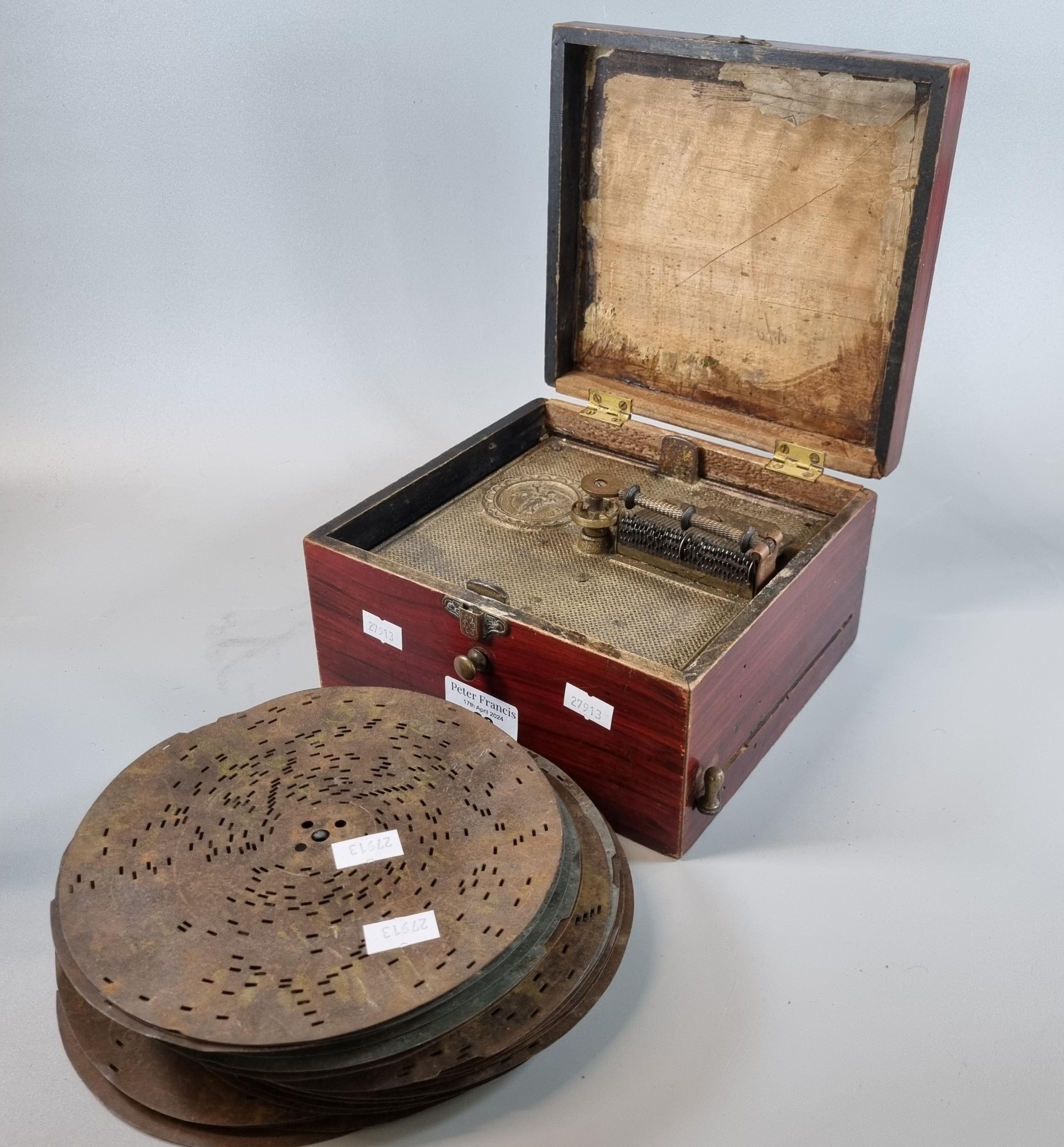 Late Victorian disc player in grained box together with an assortment of metal discs. (B.P. 21% +
