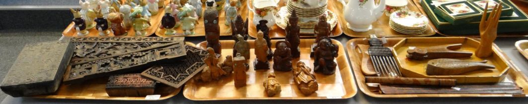 Three trays of carved wooden items to include: various figures; East Asian, Māori Tiki, Chinese; Liu