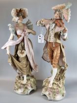 Pair of Royal Dux figures, of a musician playing his violin and a maiden in floral shawl and bonnet.