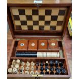 Early 20th century mahogany games compendium, the box containing various chess pieces, card boxes