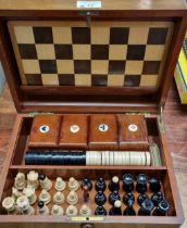 Early 20th century mahogany games compendium, the box containing various chess pieces, card boxes