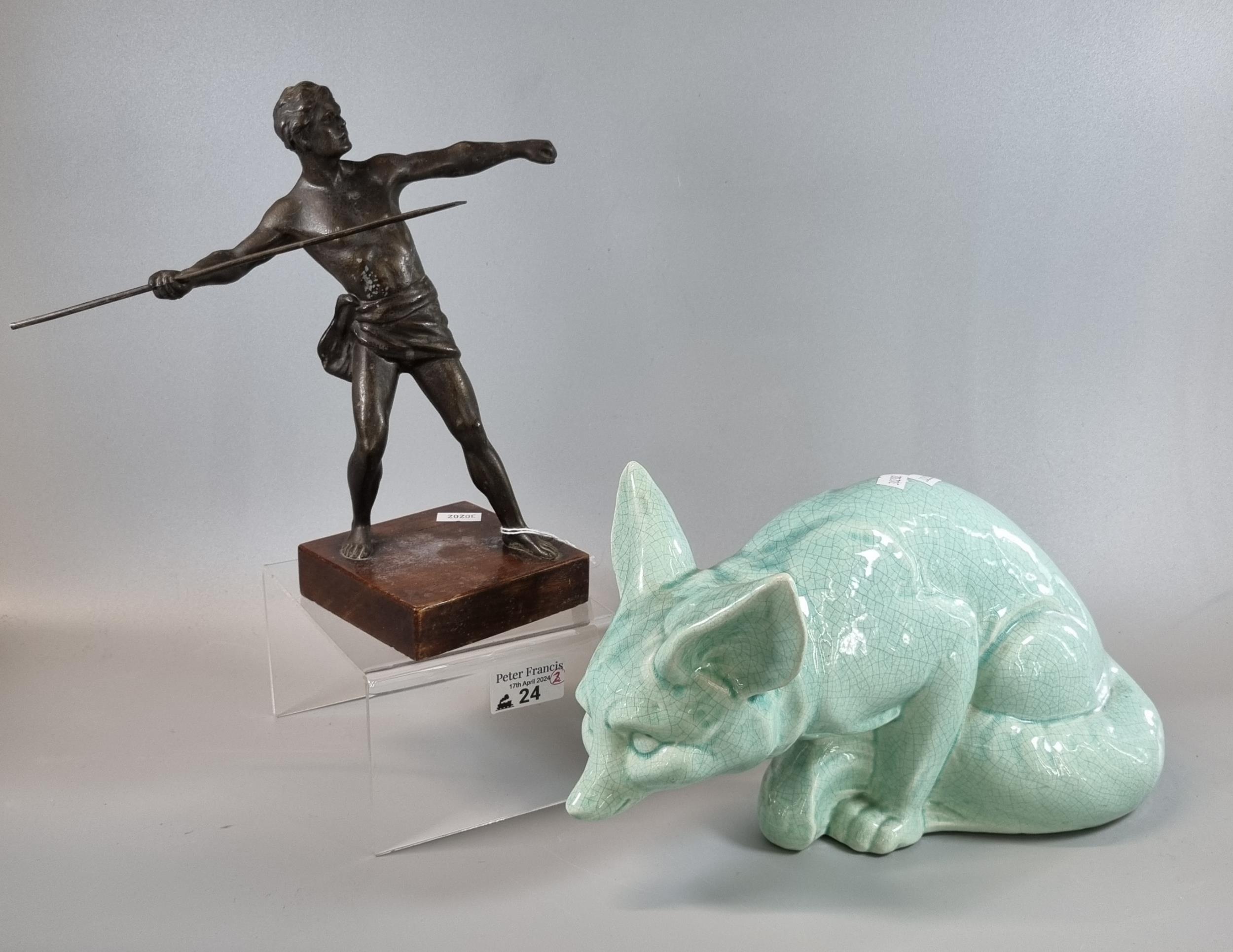 Celadon crackle glazed study of a seated fox, together with a spelter figure of a Greek javelin