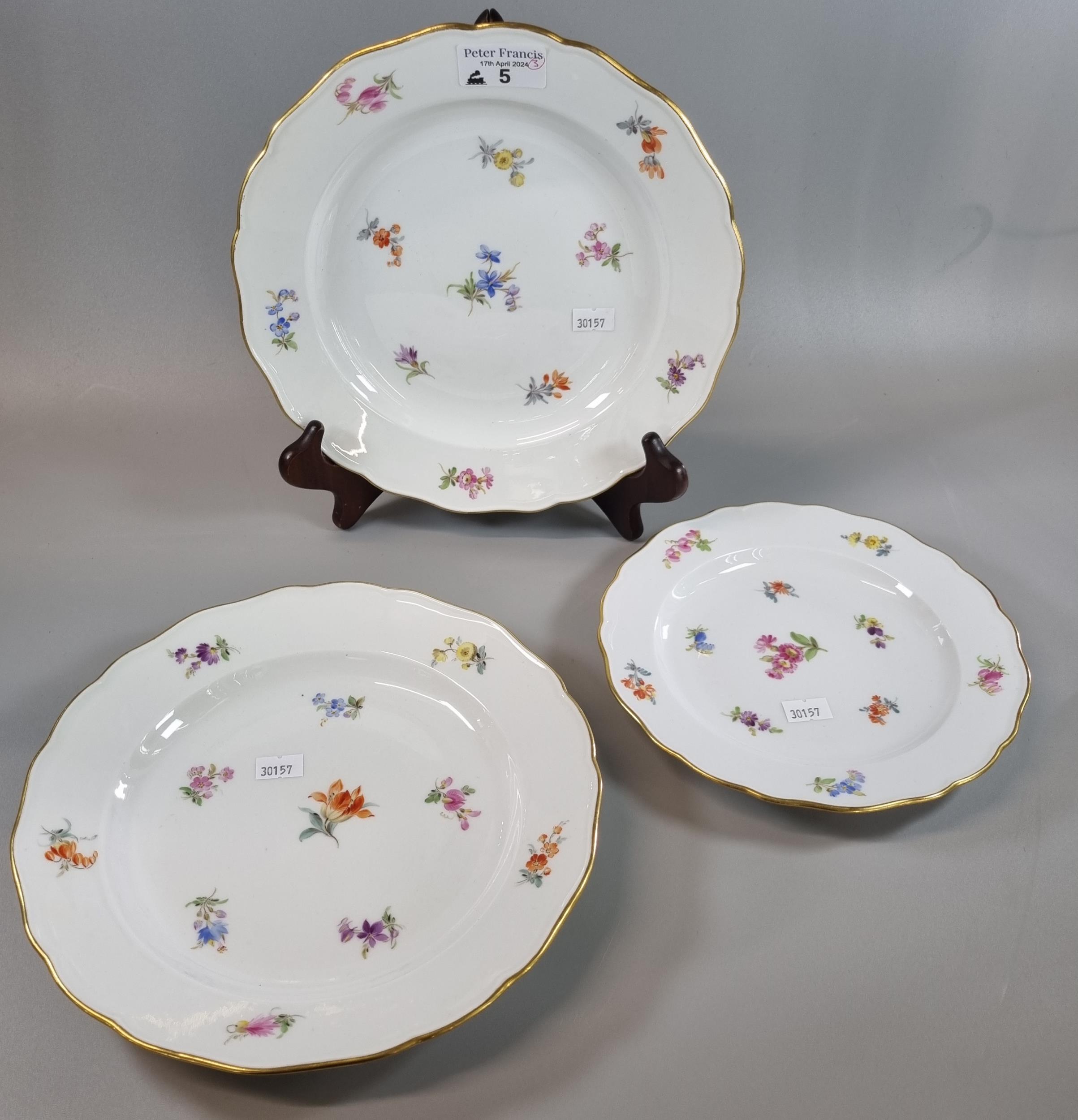 Pair of Meissen porcelain plates, with gilt rims and floral sprays together with a similar smaller