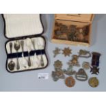 Small wooden cigar box containing assorted Military insignia, a WWI Victory Medal awarded Private