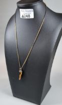 9ct gold chain with tiger's eye claw design pendant. 6g approx. (B.P. 21% + VAT)