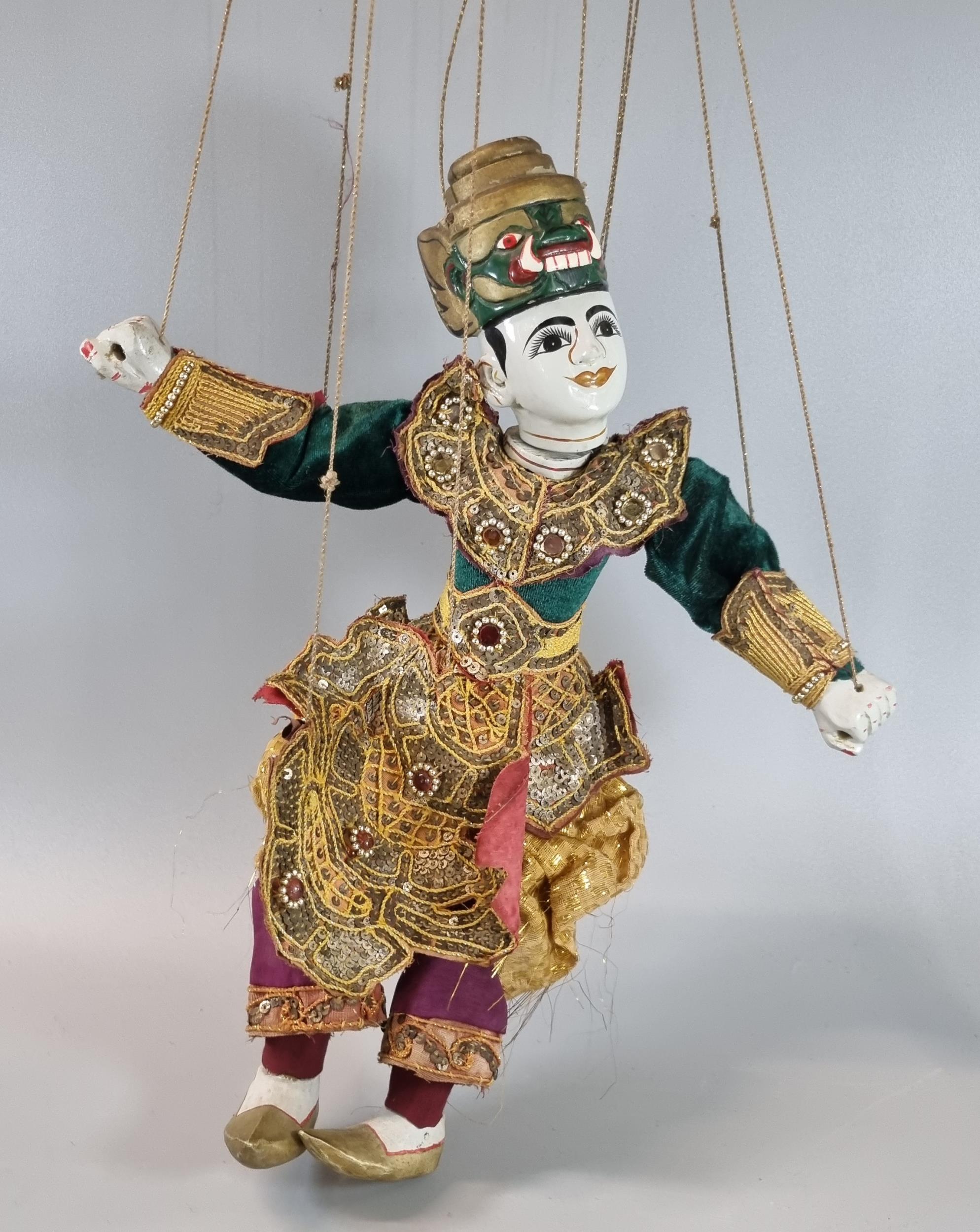 Thai or Indian Marionette fabric and wooden puppet with traditional ornament embroidered outfit. (