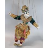 Thai or Indian Marionette fabric and wooden puppet with traditional ornament embroidered outfit. (
