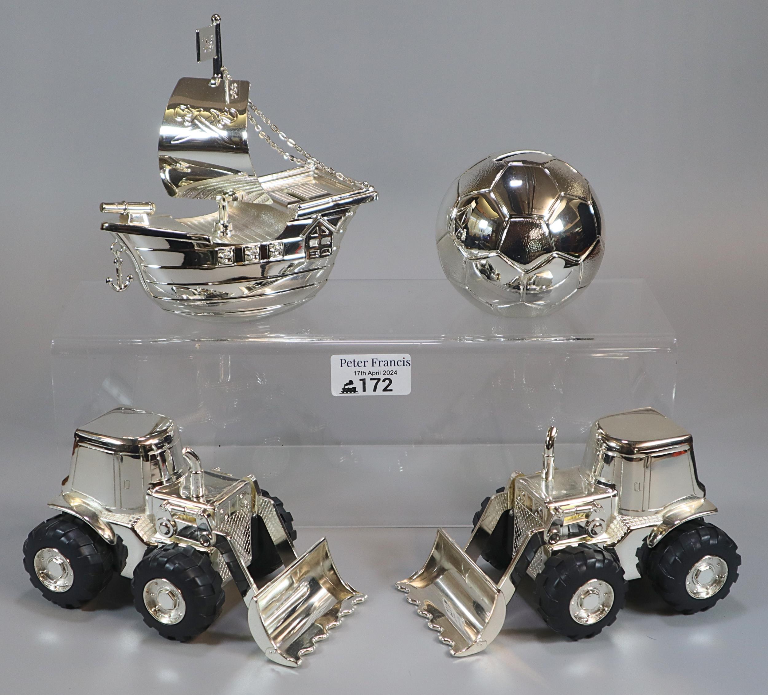 Four silver plated money boxes in the form of two digger tractors, a pirate ship and a football. (