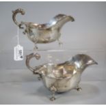 Pair of George V silver sauce boats each standing on three cabriole legs and hoof feet. By Josiah