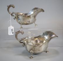 Pair of George V silver sauce boats each standing on three cabriole legs and hoof feet. By Josiah