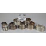 A bag of various silver napkin rings, together with 1 silver plated, decorated with bears. The