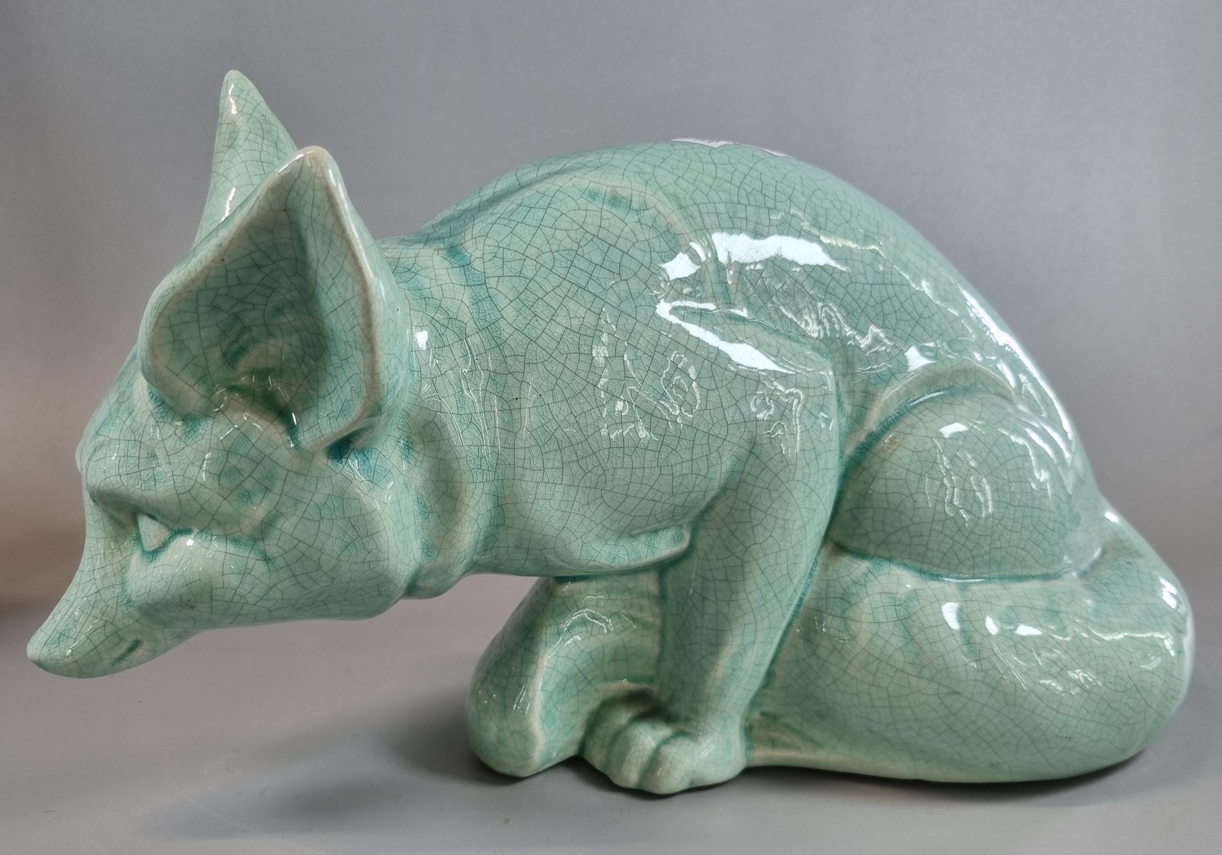 Celadon crackle glazed study of a seated fox, together with a spelter figure of a Greek javelin - Image 2 of 3