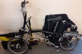 Brompton folding bicycle with textile carrying bag, additional Brompton bag with Joe Blow foot