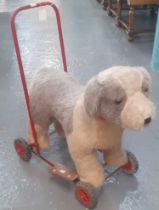 Tri-ang push along child's fabric dog on four wheeled tubular frame. (B.P. 21% + VAT)