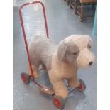 Tri-ang push along child's fabric dog on four wheeled tubular frame. (B.P. 21% + VAT)